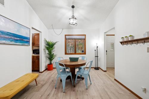 a dining room with a table and chairs at Enchanted Woods Hideaway in Kimberling City