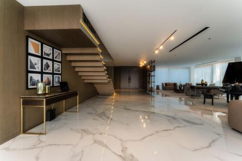 a lobby with a marble floor and a staircase at Nurai Water Villa By Luxury Explorers Collection in Abu Dhabi