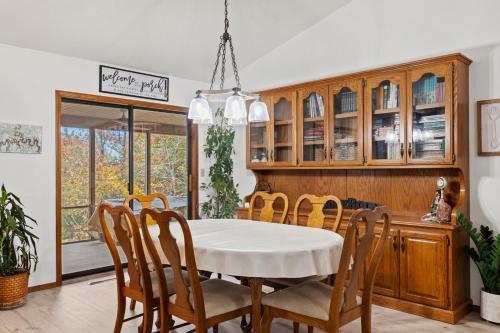 a dining room with a white table and chairs at Enchanted Woods Hideaway in Kimberling City
