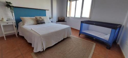 a small bedroom with a bed and a mirror at Casa M de mar - Vistas 180º in Corralejo