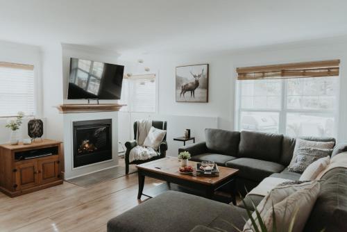 a living room with a couch and a fireplace at Mont-Blanc 2 - Direct access to hiking, beach & pool at Mont-Blanc in Mont-Blanc