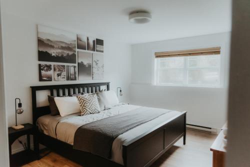 a bedroom with a large bed with white walls at Mont-Blanc 2 - Direct access to hiking, beach & pool at Mont-Blanc in Mont-Blanc