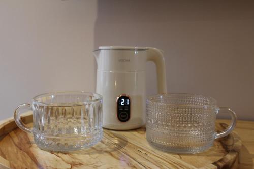 a blender and two glasses on a wooden table at The Kings Head Inn, Norwich - AA 5-Star rated in Norwich