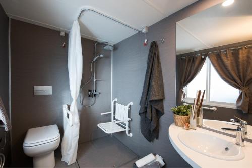 a bathroom with a toilet and a sink at Camping Eden Glamping in Dormelletto