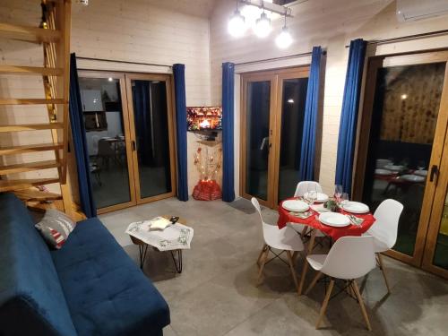 a living room with a table and a blue couch at Kemping i Domki nad stawem in Harsz