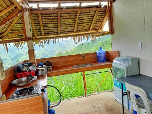 a kitchen with a counter and a view of a mountain at MIRA AgroPark in Kuyambay