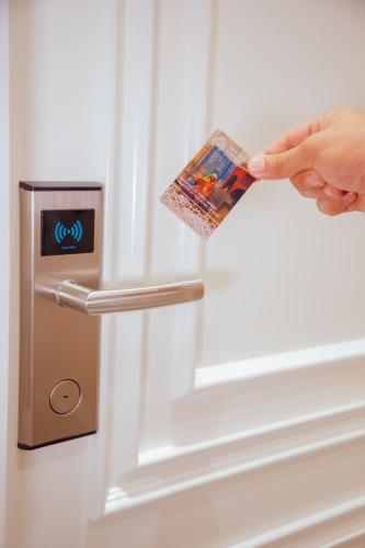 a person opening a door with a credit card at HOTEL SILK ROAD EMPIRE SAMARKAND in Samarkand