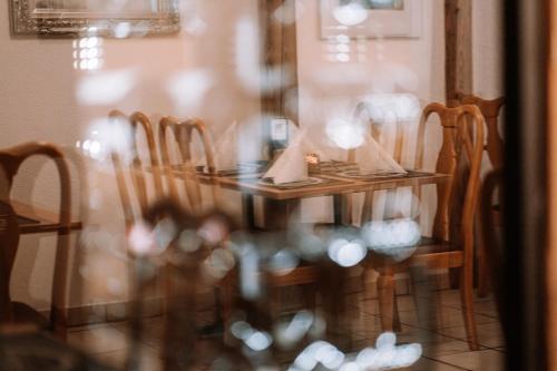 a dining room table with wooden chairs at Hotel Garni Familie Gruber in Spital am Pyhrn
