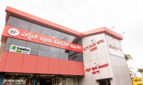a building with a sign on the side of it at Treebo Elite Plaza, 700 Mtrs From Madikeri Fort in Madikeri
