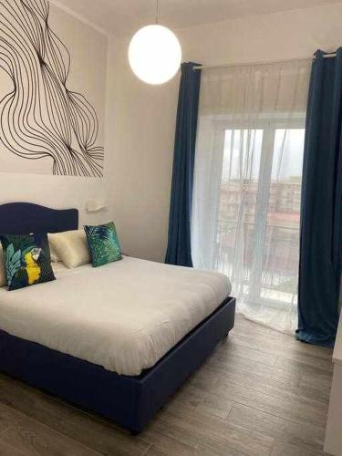 a bedroom with a bed and a large window at Residenza da Zia Donata in Ercolano