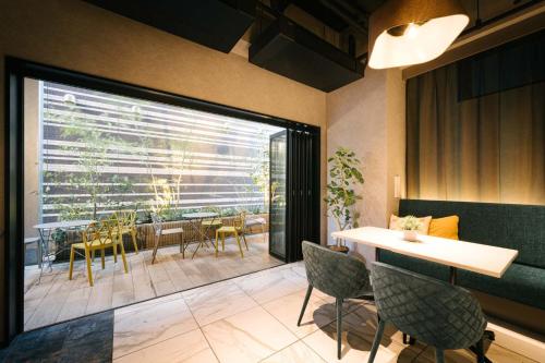 a dining room with a table and chairs at R Hotel Namba South in Osaka