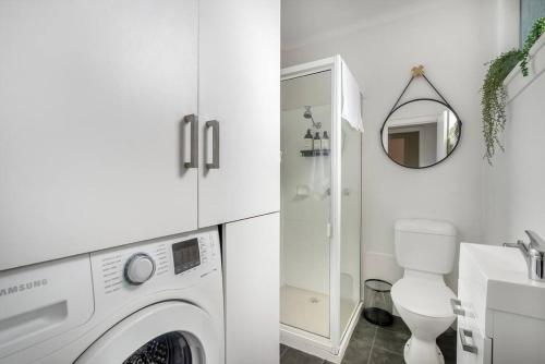 a white bathroom with a washing machine in it at Haven on Timsbury, Urban Escape near Mona in Derwent Park