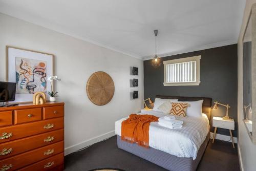 a bedroom with a large bed and a dresser at Haven on Timsbury, Urban Escape near Mona in Derwent Park