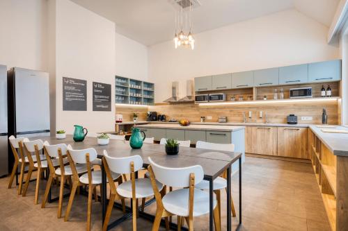 a large kitchen with a table and chairs at lyf Schönbrunn Vienna in Vienna