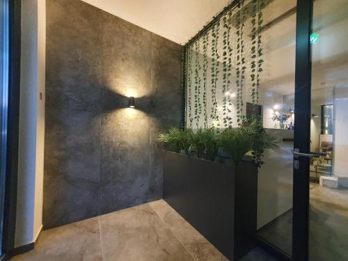 a hallway with a wall with plants on it at Avenue21 in Zagreb