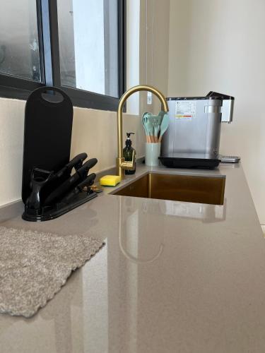 a kitchen counter with a sink and a mixer at Urban Suites, Signature Collection by Stellar ALV in Jelutong