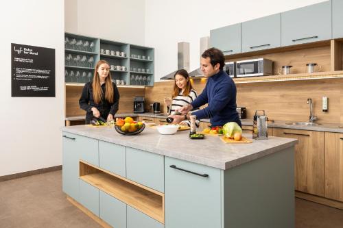 a group of people in a kitchen preparing food at lyf Schönbrunn Vienna in Vienna