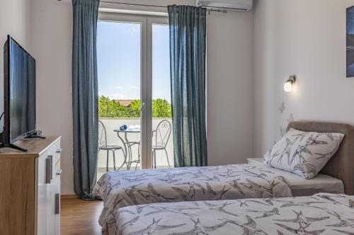 En eller flere senge i et værelse på Villa Melani Vita by Villa Plus