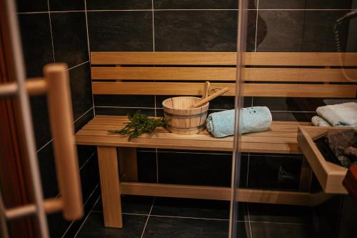 a wooden table with a mortar and pestle on it at Alpenhotel & Aparthotel Lanz in Hohentauern
