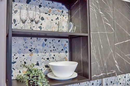 a shelf with a bowl and glasses on it at Best Apartments on Kyryla & Mefodia in Mukacheve