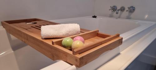 a wooden tray with three eggs in front of a sink at Views of the Tamar River in Clarence Point