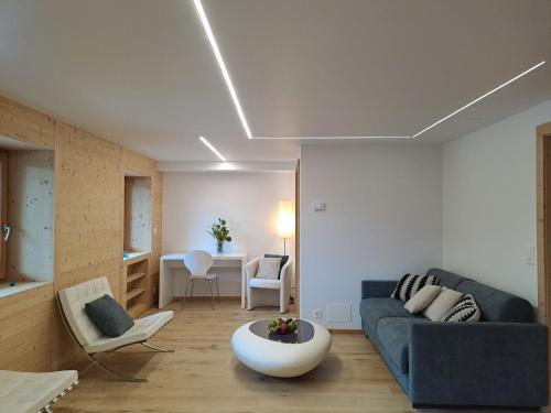 a living room with a couch and a table at Apartment Etoile du Matin rez by Interhome in Champex