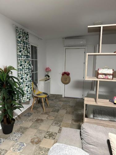 a living room with a couch and a chair at LOFT EN PATIO DE CASA TÍPICA DE PUEBLO in Villafranca de Córdoba