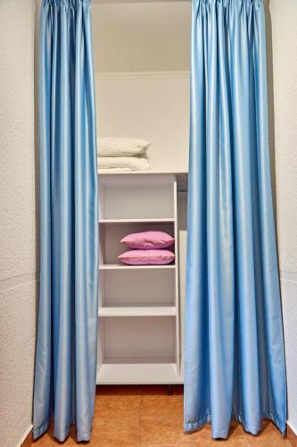 a room with blue curtains next to a bunk bed at Best Apartments on Kyryla & Mefodia in Mukacheve