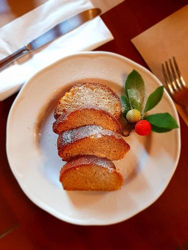 a plate with three pieces of bread on a table at Helicon Muses Friendly Mountain B&B Guesthouse in Evangelístria