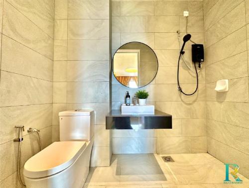 a bathroom with a toilet and a sink and a mirror at Sky Trees by Rentradise in Johor Bahru