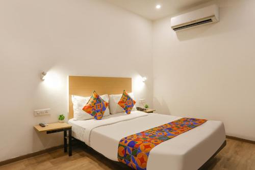 a bedroom with a large bed in a room at FabHotel Golden World in Ghaziabad