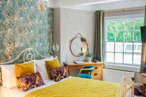 a bedroom with a bed and a desk and a window at Old Rectory House & Bedrooms in Redditch