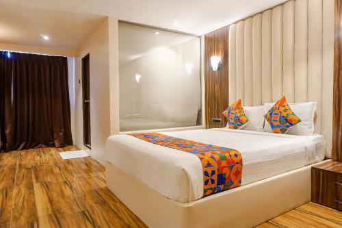a bedroom with a large bed in a room at FabHotel Dreams Inn in Pune