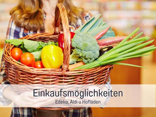 a woman holding a basket filled with vegetables at RamosHansenHof Fewo Nordlicht 6 Personen Hund inklusiv in Steinberg