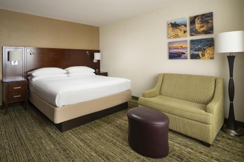 a hotel room with a bed and a chair at San Diego Marriott La Jolla in San Diego