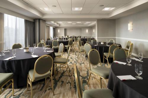 a room with tables and chairs in a room withwindows at San Diego Marriott La Jolla in San Diego
