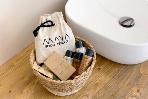 a basket ofentedented items next to a toilet at Maya Beach Resort in Massa Lubrense