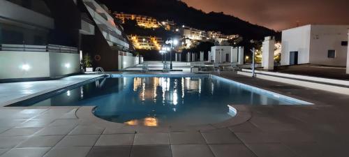 a swimming pool in the middle of a building at night at Notre paradis à Sesimbra in Sesimbra