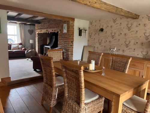 a dining room with a wooden table and chairs at The Paddocks in Moulton Chapel