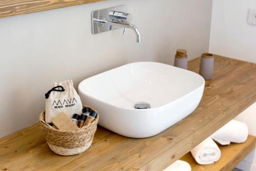 a bathroom with a white sink on a wooden counter at Maya Beach Resort in Massa Lubrense