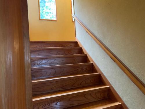 a set of stairs in a home with wooden floors at HOTEL LT Kitchen Yugawara in Yugawara
