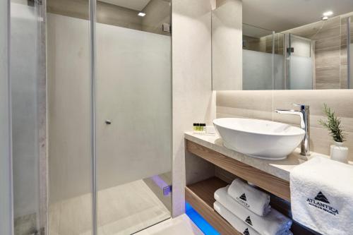 a bathroom with a sink and a shower at Atlantica Bay - Adults Only in Limassol