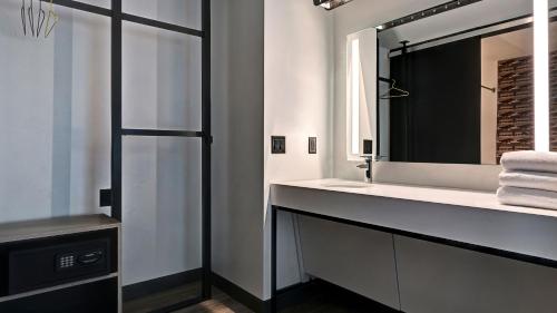 a bathroom with a sink and a mirror at Aloft Mooresville in Mooresville