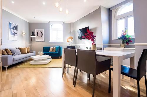 a living room with a table and chairs and a couch at Welcome London Theatreland in London