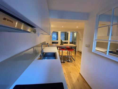 a kitchen with a sink and a counter top at TRIPLEX NEUVICE in Liège