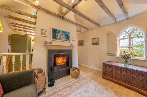an image of a living room with a fireplace at A fairy-tale luxurious cottage - The Tea Caddy in Colchester