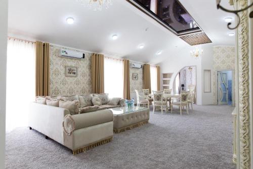 a living room with a couch and a table at Alexander Hotel in Samarkand