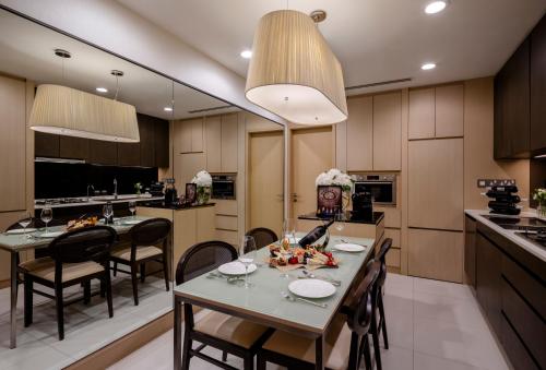 a kitchen and dining room with a table and chairs at Fraser Suites Singapore in Singapore