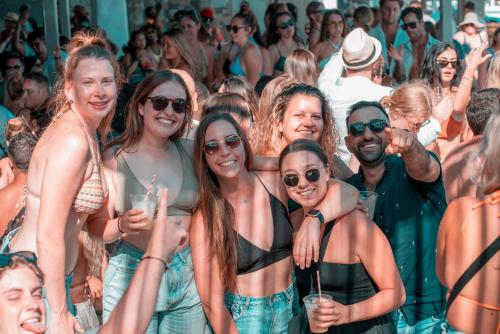 a group of people posing for a picture at a party at Paradise Beach Camping - Adults Only in Paradise Beach