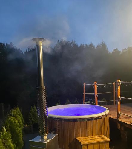 a hot tub sitting on top of a deck at Oskarówka Kaszuby z balią in Gołubie